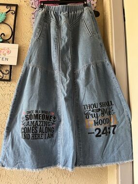 Denim Maxi Skirt with Printed Slogans - Blue. Length is 39” waist is elastic.